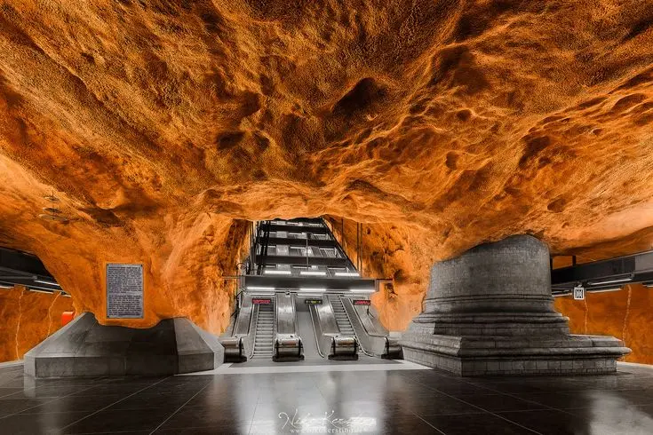 Orange cave walls at Rådhuset metro station Stockholm
