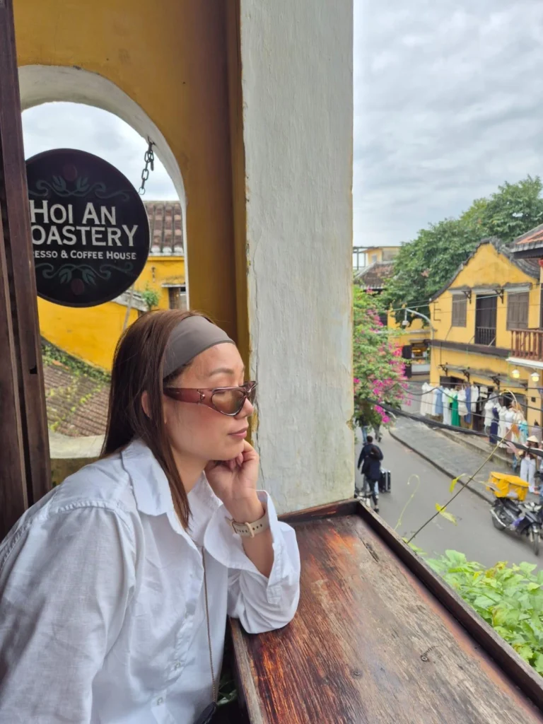 Cozy coffee shop with lanterns and rustic wooden décor on a narrow street in Hội An Ancient Town, Vietnam