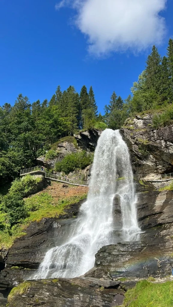 Waterfalls and blooming orchards along Hardangerfjord, one of Norway's most beautiful fjords, near Bergen.