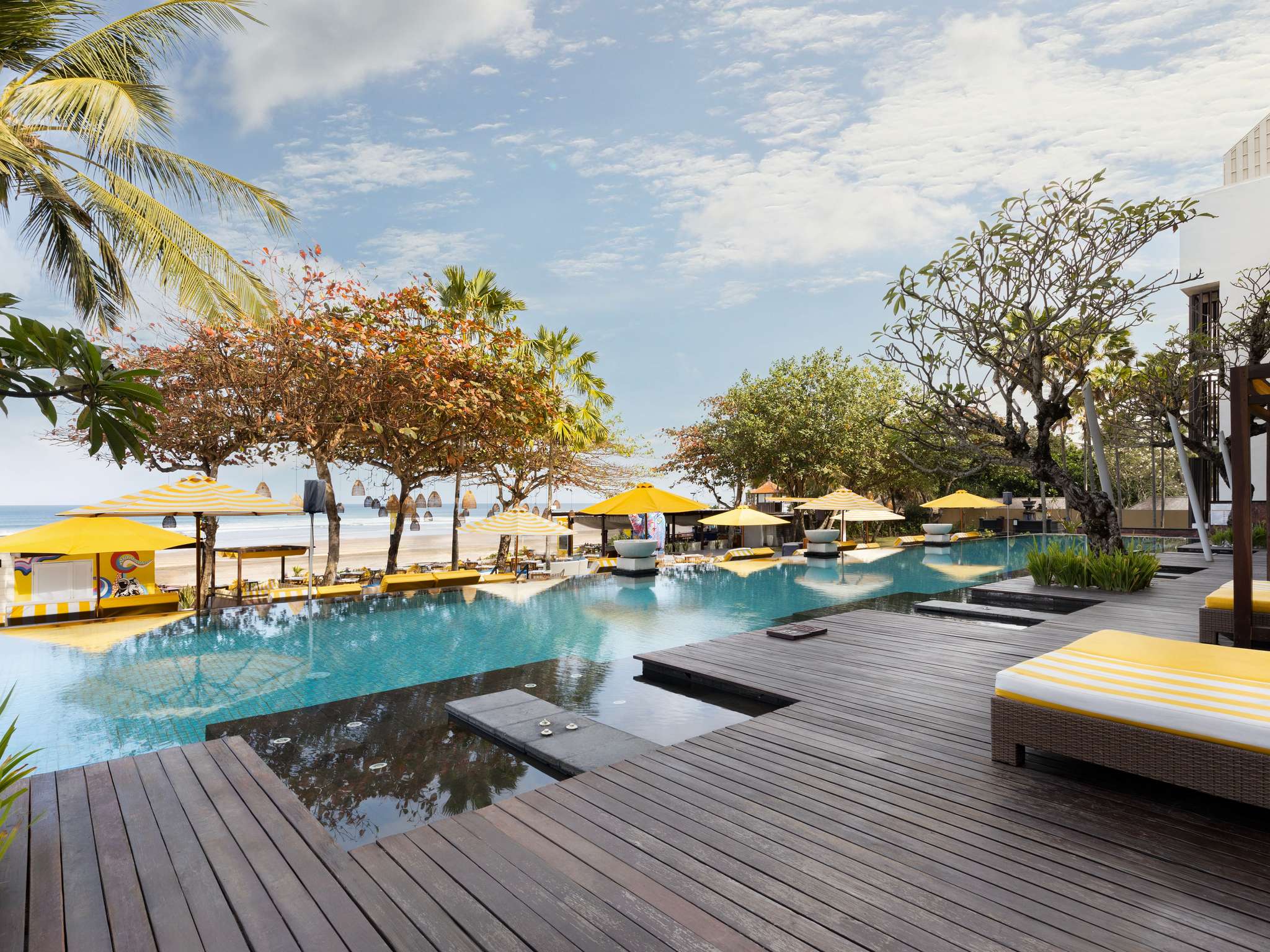 Seminyak beach resort with palm trees and sunset views