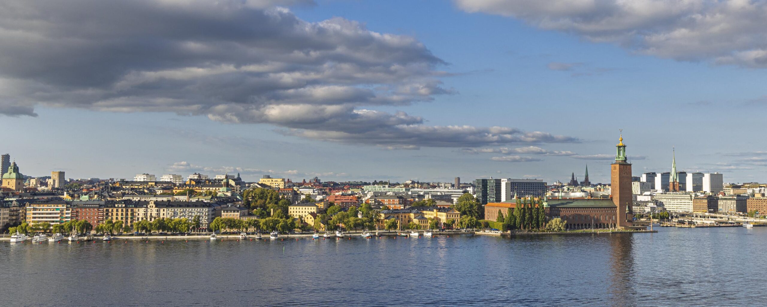 Stockholm waterfront skyline view with historic buildings and harbor boats in Sweden