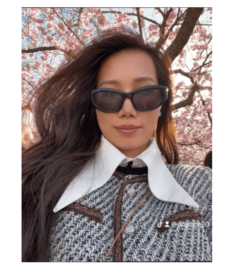 Ann taking a selfie at Kungsträdgården in Stockholm during cherry blossom season
